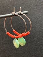 Hoop earrings with green mother-of-pearl beads and stainless steel