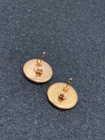Cream colored salmon leather and rose gold stainless steel stud earrings
