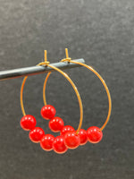 Hoop earrings with red coral beads and gold stainless steel